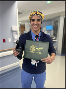 awardee wearing a headband of daisies, daisy award statue, and certificate.