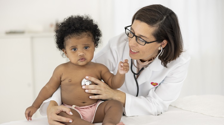Female doctor with baby girl patient