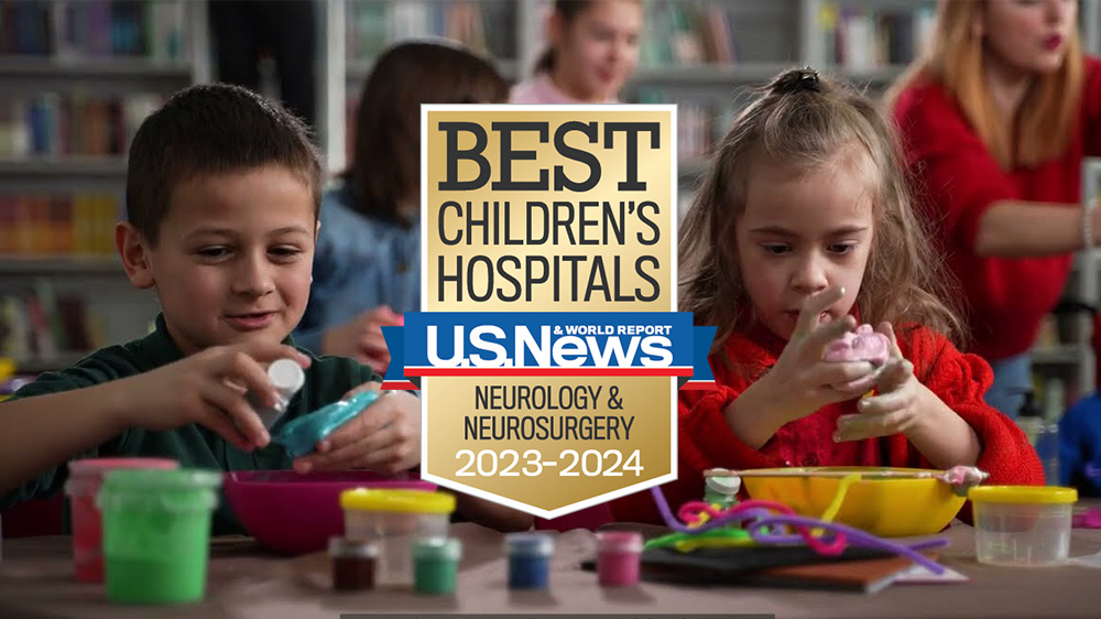 two neurodivergent children play in a classroom.