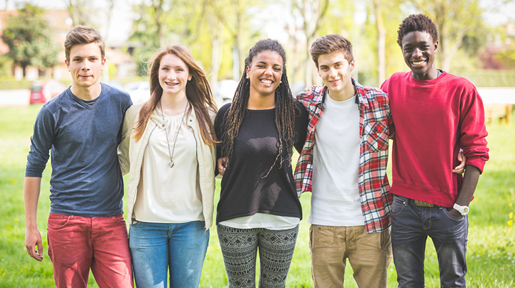 group of teenage boys and girls standing together.