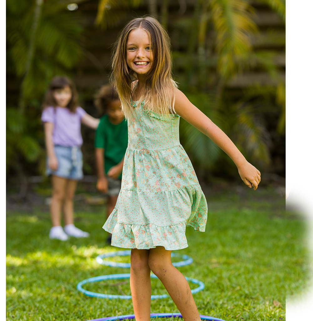 blue eyed girl playing on the yard.