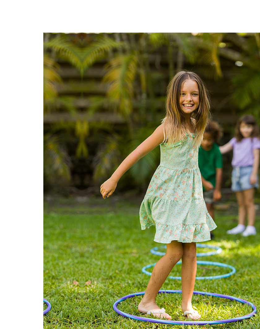 blue eyed girl playing on the yard.